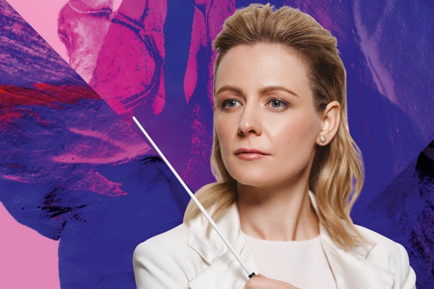 Gemma New conductor - wearing white suit and holding baton