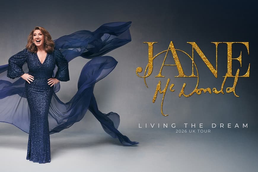 Jane McDonald smiling in a glittery ball gown